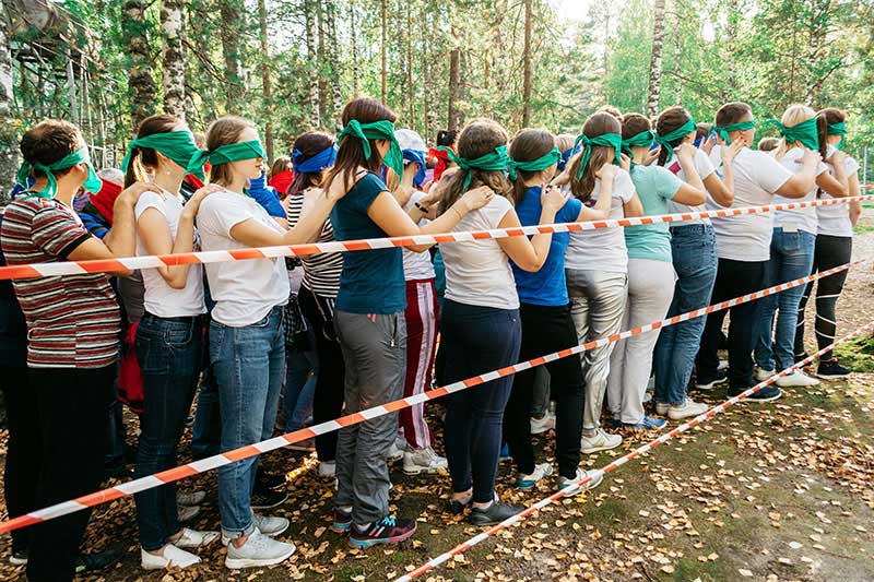Bei einem Vertrauensspiel wird das gegenseitige Vertrauen innerhalb der Gruppe gesteigert und gefördert.