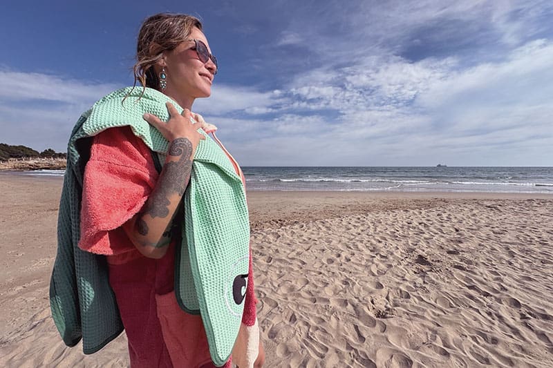 Shania-mit-Poncho-und-Handtuch-von-Wave-Hawaii-am-Strand
